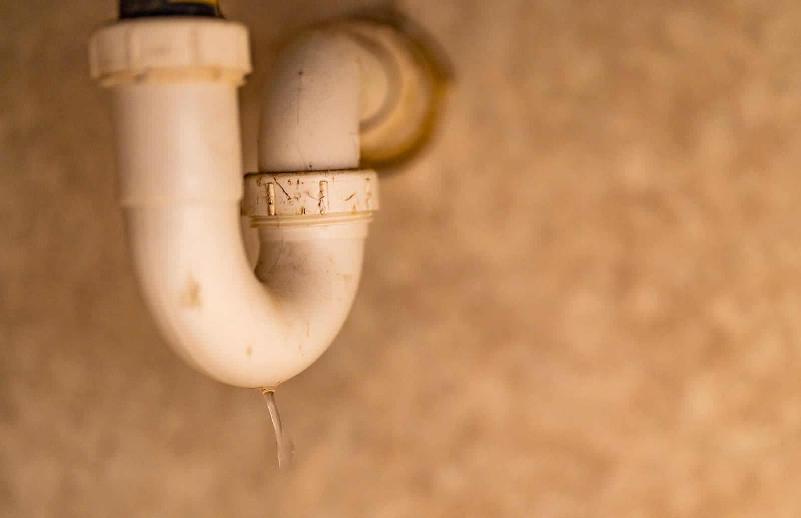 A dripping P-trap under a sink
